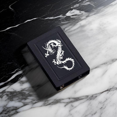 Ace Diamond lighter featuring a striking engraved silver dragon design, displayed against a glossy black marble background.