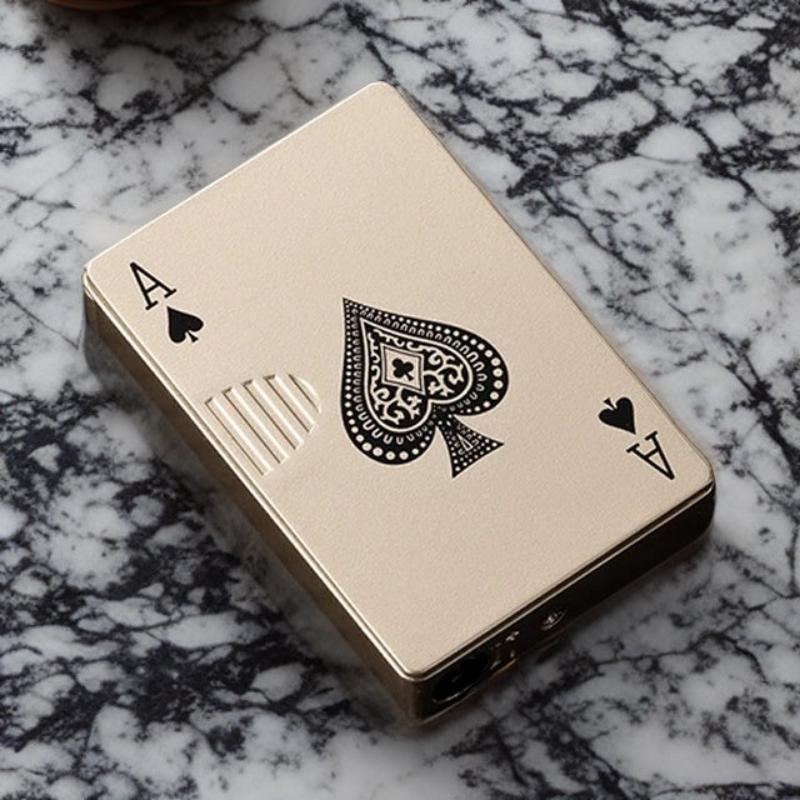 Close-up view of the ace of spades lighter with intricate gold detailing, placed on a polished marble surface.