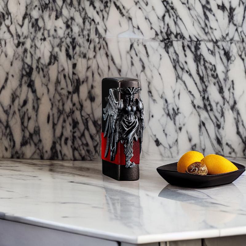 Angel of Flame lighter positioned on a marble backdrop, with a red and metallic finish.