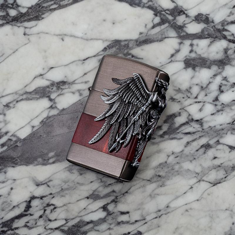 Angel of Flame lighter resting on a marble surface, showcasing its intricate angel wing design.