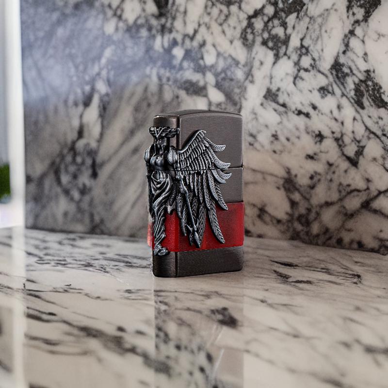 Angel of Flame lighter standing upright on a marble background, emphasizing its winged design.