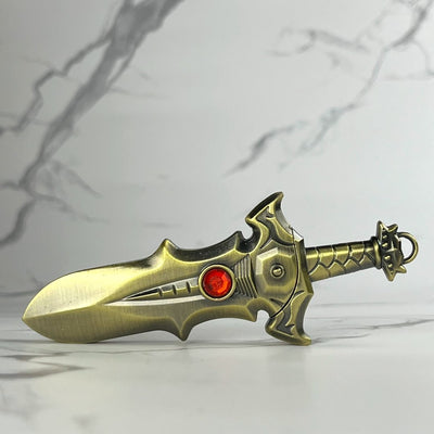 Brass-colored fantasy sword lighter with red jewel in the center and rugged blade edges.