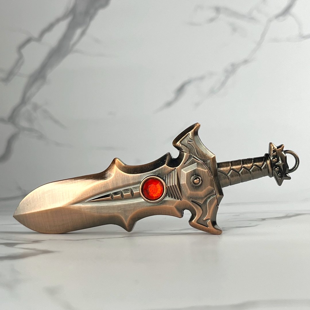 Bronze fantasy-style sword lighter with red gemstone accent and detailed hilt design.