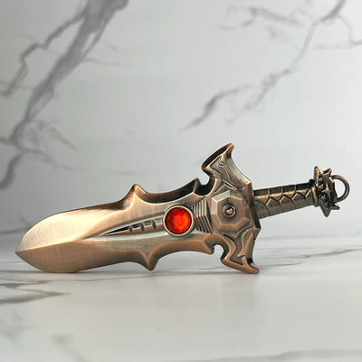 Bronze fantasy-style sword lighter with red gemstone accent and detailed hilt design.