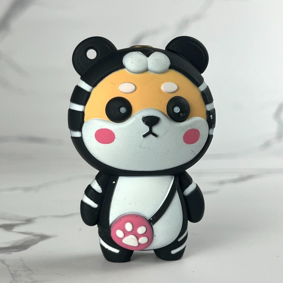 Black and white tiger-themed cartoon bear lighter with pink paw detail