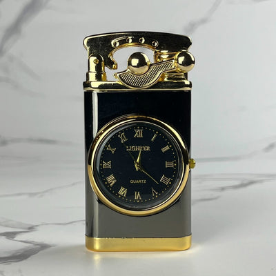 Retro black and gold refillable lighter with built-in quartz clock and vintage-style ignition lever, shown on marble background.