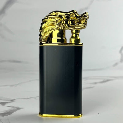Black lighter with a gold dragon head-shaped ignition cover.
