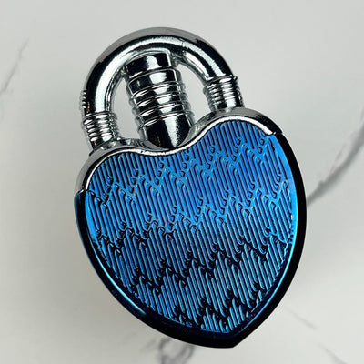 Close-up of a metallic blue heart-shaped lock lighter with engraved pattern.