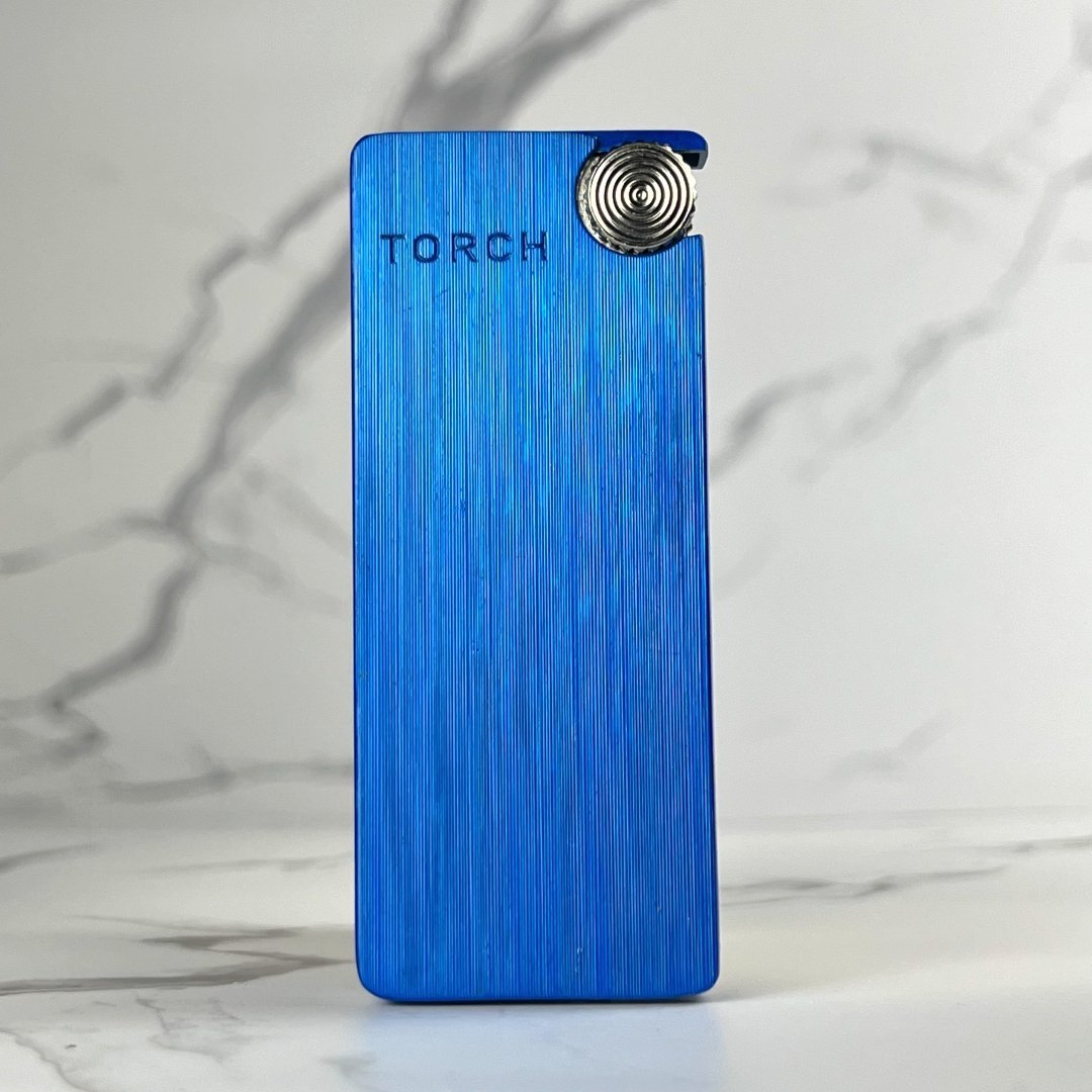Electric blue torch lighter with minimalist design and textured vertical grain.