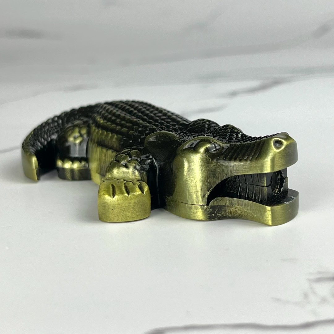 Brass crocodile-shaped novelty torch lighter with textured detailing.