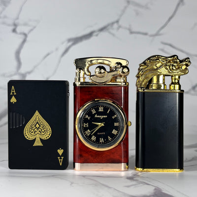 Elite Flame Bundle – set of three refillable butane lighters including a Black & Gold Dragon Lighter, Time Torch Lighter, and Black Ace Poker Card Torch Lighter displayed side by side
