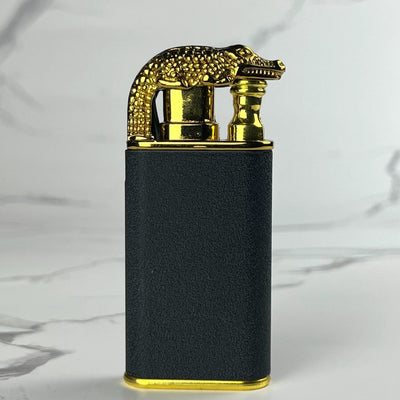 Black and gold crocodile-shaped torch lighter standing upright.
