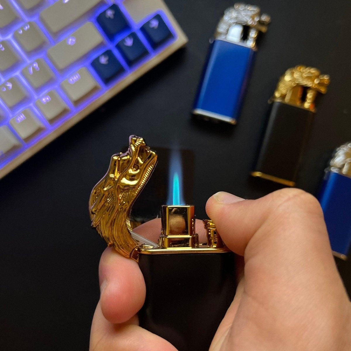 Hand lighting a gold dragon lighter with other models in background.