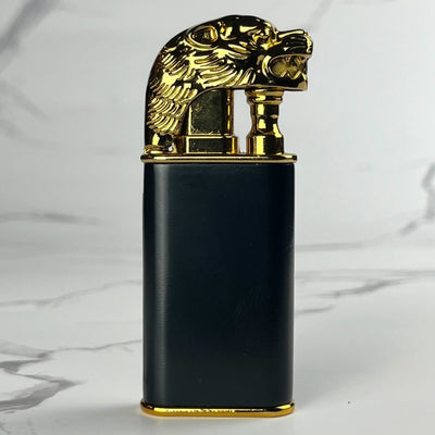 Black lighter featuring a detailed gold lion head as the lid.