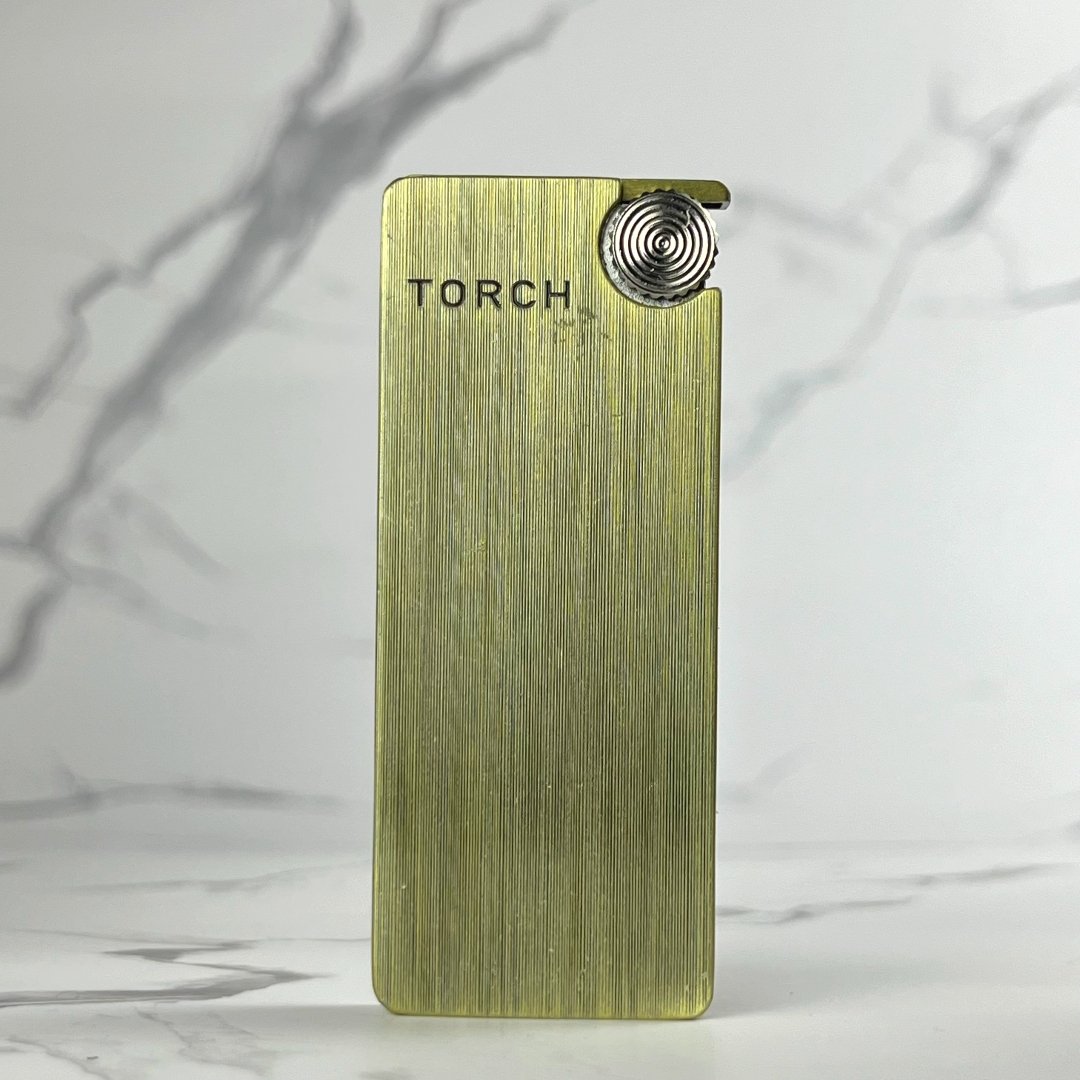 Brushed gold slim torch lighter featuring a clean engraved design and metal wheel.