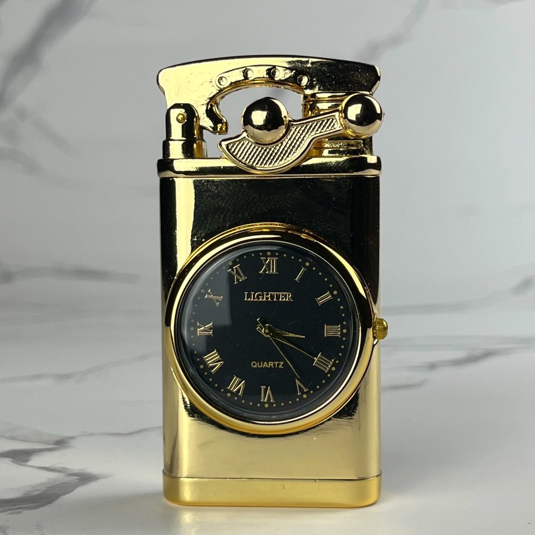 Gold-tone refillable lighter with built-in analog clock and classic ignition lever, displayed upright on a marble background.