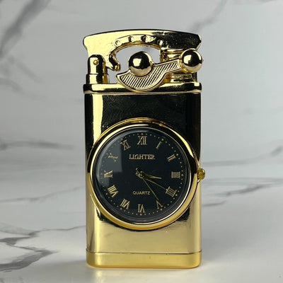 Gold-tone refillable lighter with built-in analog clock and classic ignition lever, displayed upright on a marble background.