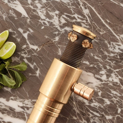 Close-up of a gold torch lighter's precision flame nozzle, highlighting its durable craftsmanship premium