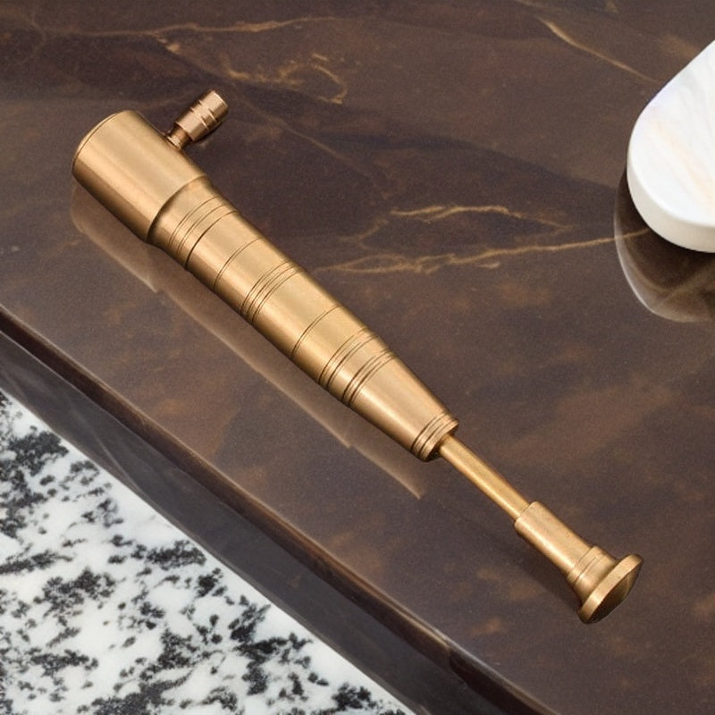 Elegant gold torch lighter with a baseball bat-inspired design displayed on a polished marble surface. premium