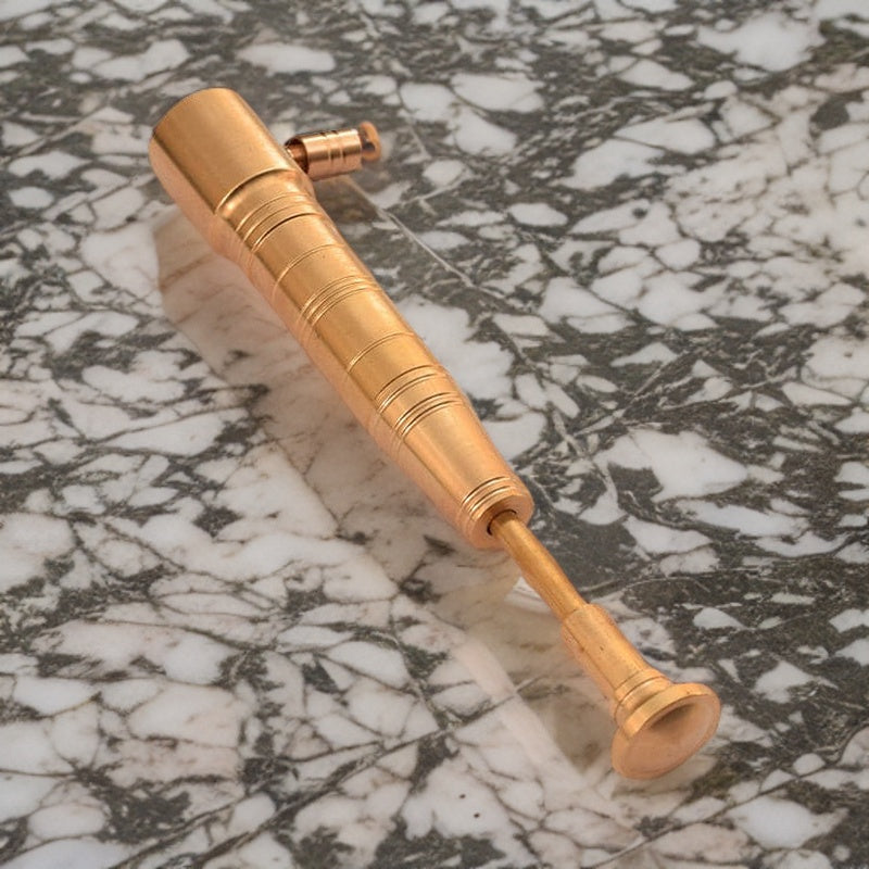 Refined gold torch lighter with precision flame, blending style and functionality on a marble tabletop. premium