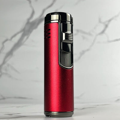 Metallic red refillable torch lighter featuring black top ignition and textured thumb grip, photographed upright on marble.